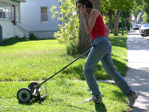 Wife mowing lawn